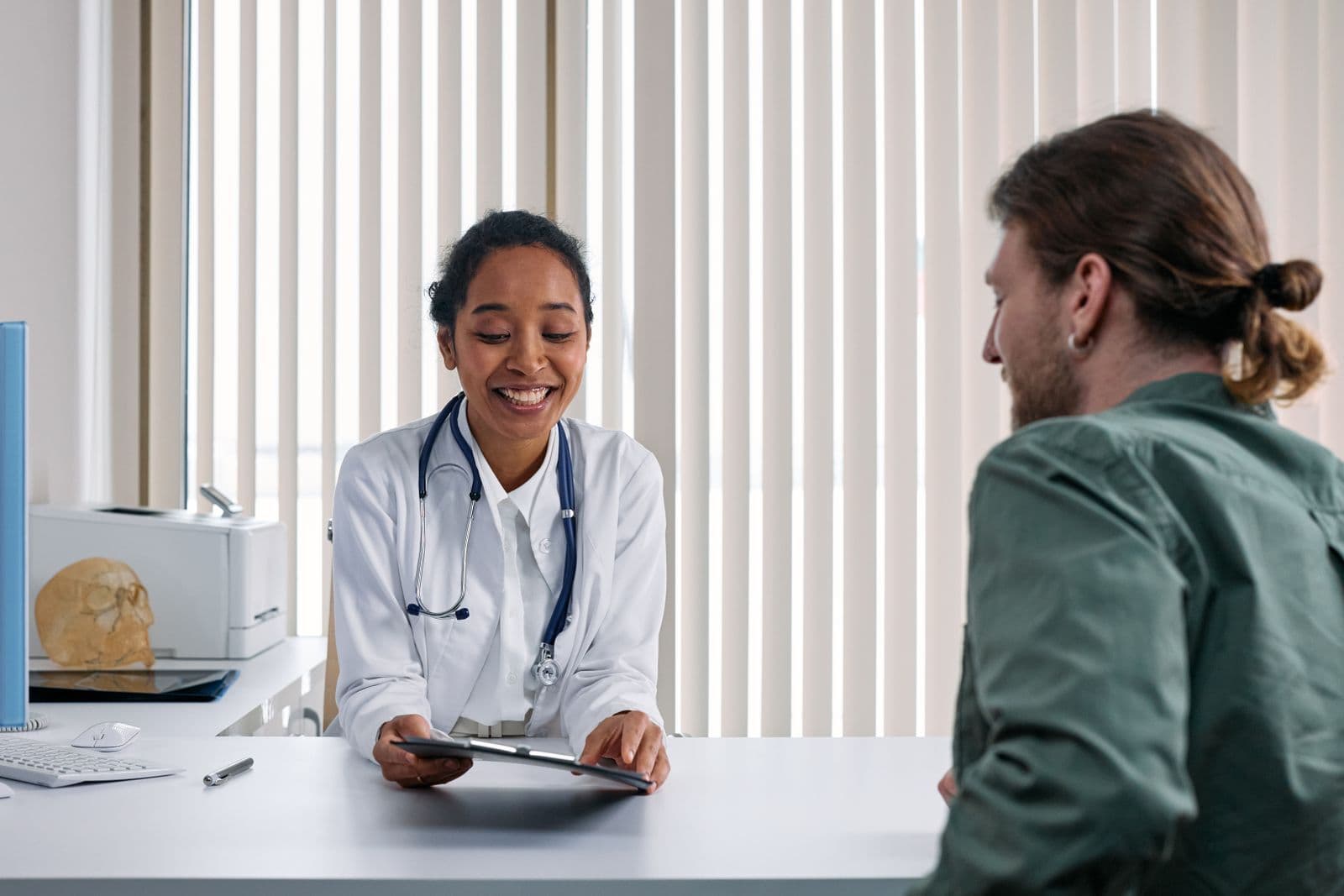 A family doctor talking with a patient in an exam room